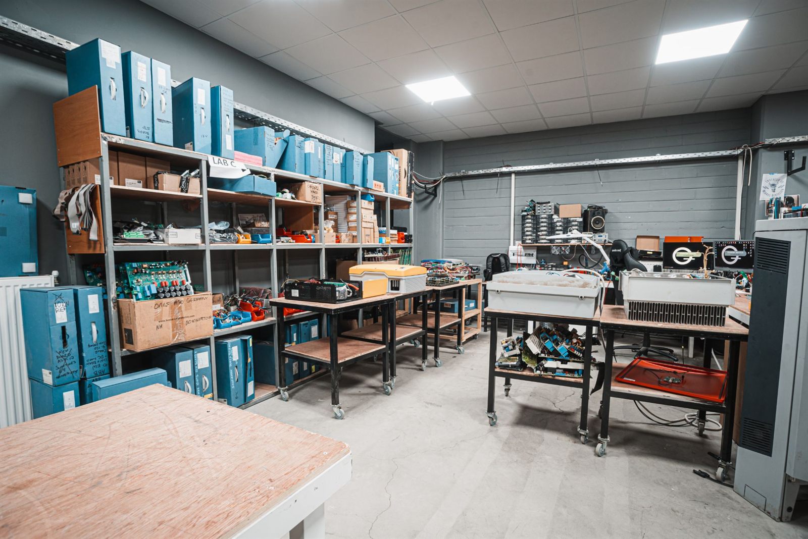 Shelves with inverter boards and spare parts in the lab