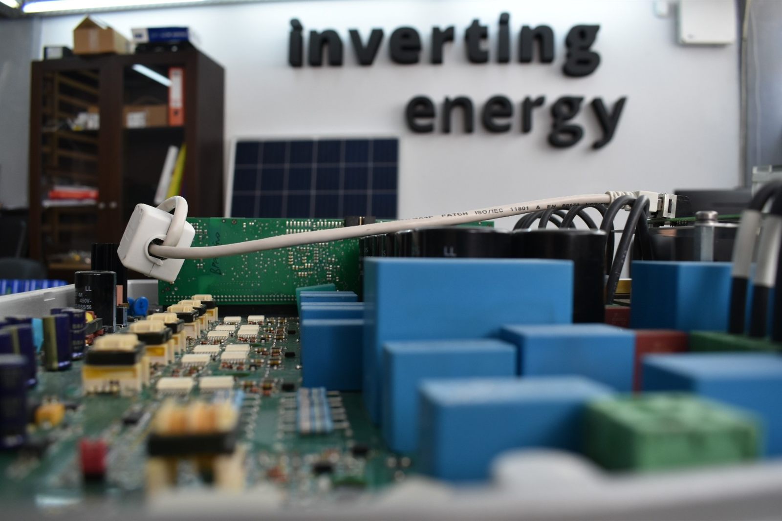 Inverter board with the motto inverting energy on the lab wall